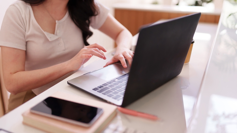 A business professional works on a laptop, representing QuickBooks ProAdvisor consulting and bookkeeping support.